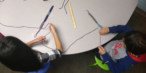 kids making paracord bracelets